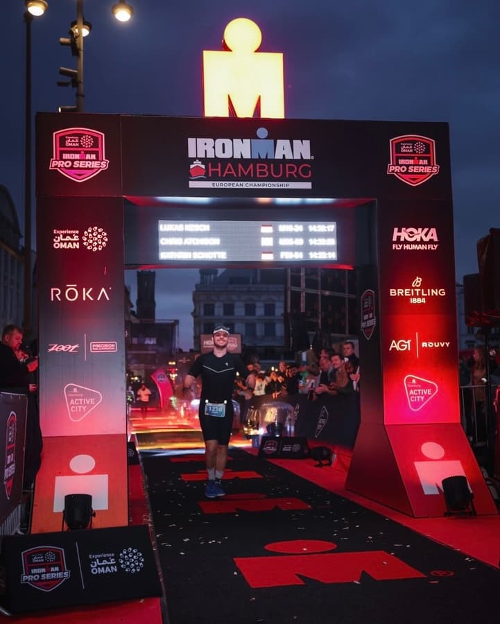 Lukas crossing the finish line at IRONMAN Hamburg 2026